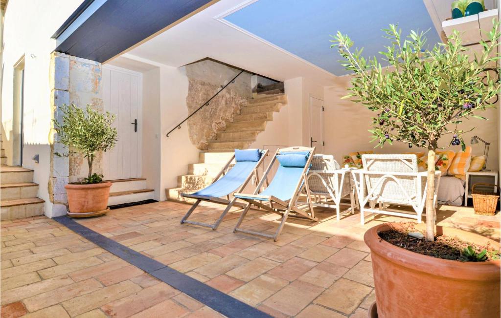 a patio with chairs and a table and stairs at Nice Home In Verfeuil With Wifi, Private Swimming Pool And Outdoor Swimming Pool in Verfeuil