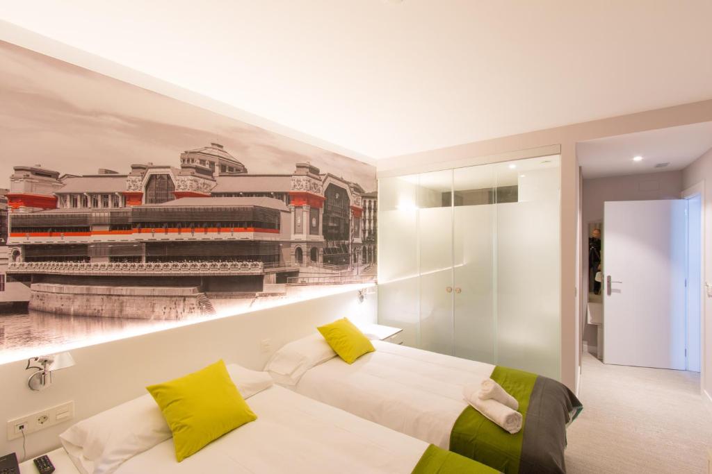 a bedroom with a wall mural of a city at Bilbao City Rooms in Bilbao