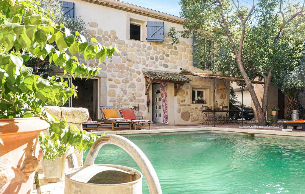 a swimming pool in front of a house at Lovely Home In Roujan With Outdoor Swimming Pool in Roujan