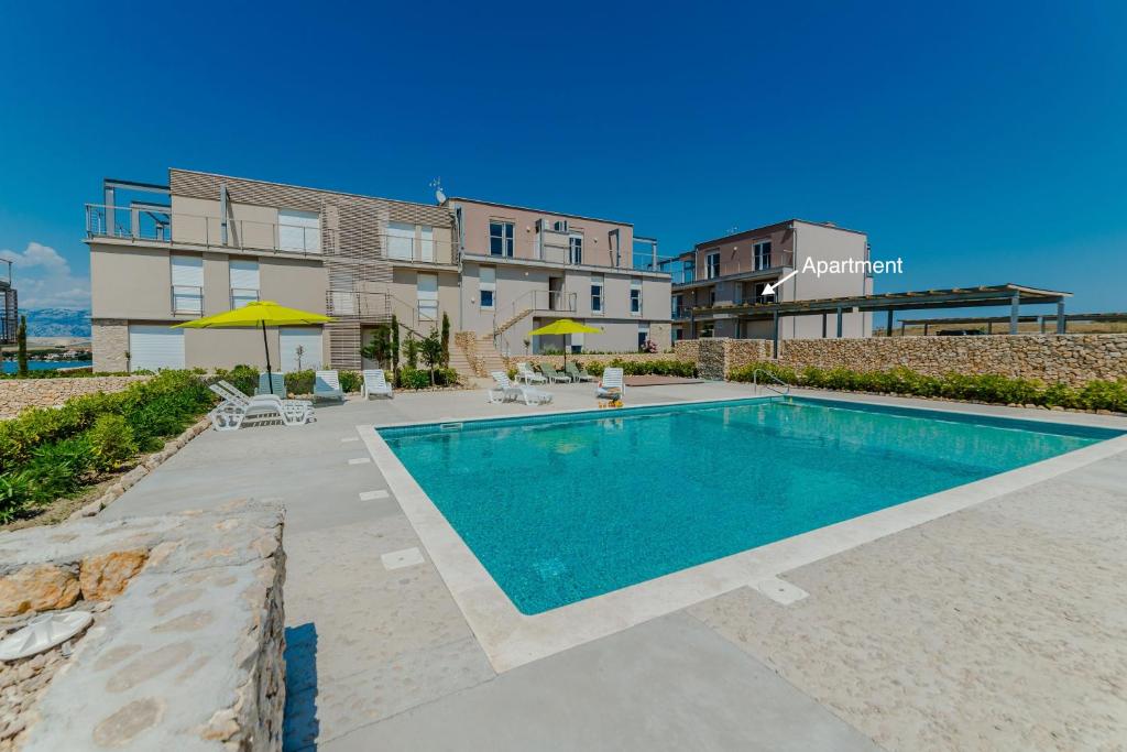 a swimming pool in front of a building at Apartment Amazing Island in Povljana
