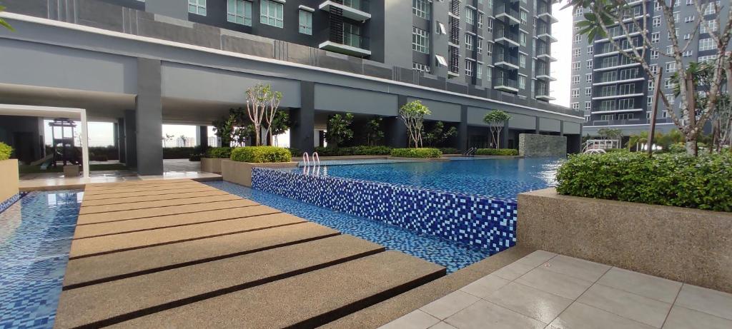 a swimming pool in the middle of a building at Bukit Rimau Instagrammable 2 Bedroom Apartment With Pool View up to 5 PAX in Shah Alam