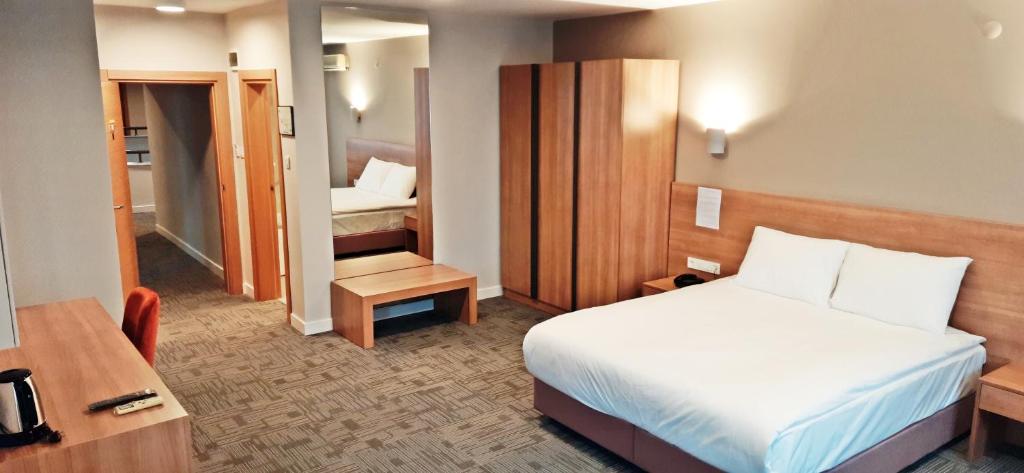 a hotel room with a bed and a small bedroom at Silivri Park Hotel in Silivri