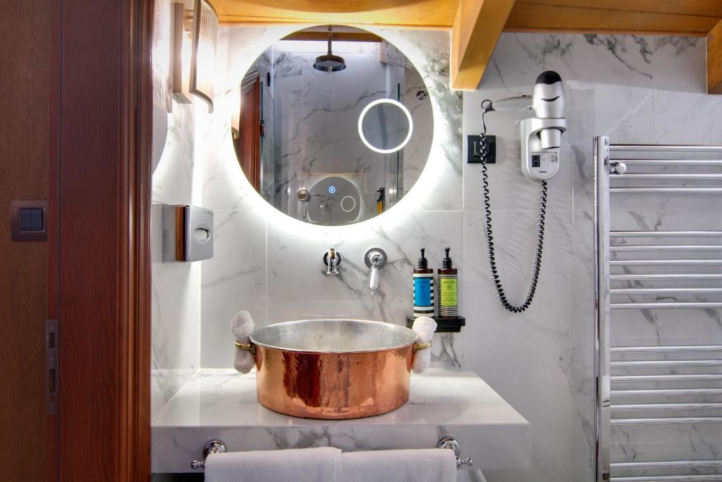 a large copper pot on a counter in a bathroom at ARCHONTARIKI Historic Boutique Hotel in Ioannina