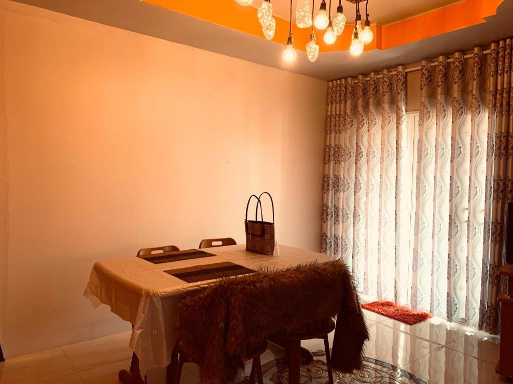 a dining room with a table and a window at Heaven Guesthouse in Pakse