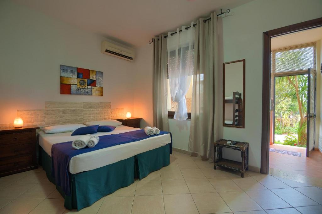 a bedroom with a large bed and a window at Appartamento Asfodelo in Villacidro