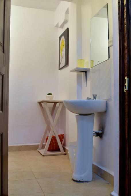 a bathroom with a sink and a mirror at Rorot Spacious one bedroom in Kapsoya with free Wifi in Eldoret