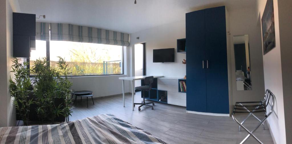 a living room with a blue cabinet and a table at Au Calme in Sint-Genesius-Rode