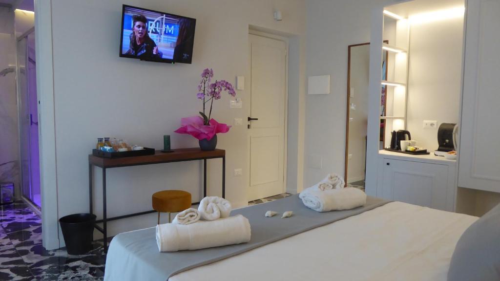 een slaapkamer met een bed en 2 witte handdoeken bij Paderagi in Santa Domenica