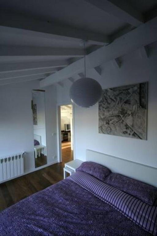 a bedroom with a purple bed and a lamp at Pensión Iturriza in Donostia-San Sebastián