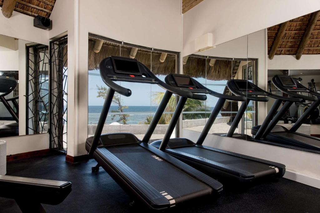 a gym with treadmills and a view of the ocean at Radisson Blu Poste Lafayette Resort & Spa (Adults Only) in Poste Lafayette