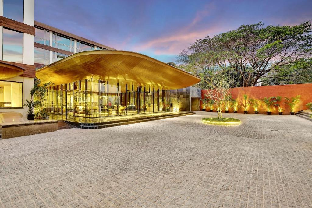 a large building with a large glass facade at Radisson Resort Goa Baga in Baga