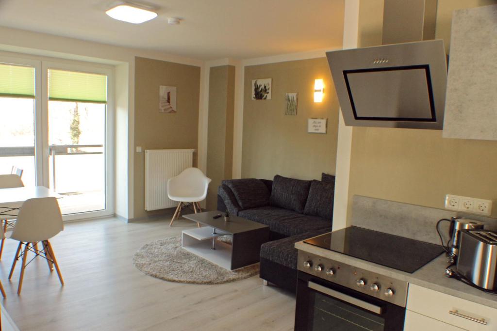 a living room with a couch and a tv at Ferienwohnungen Rittergasse in Quedlinburg