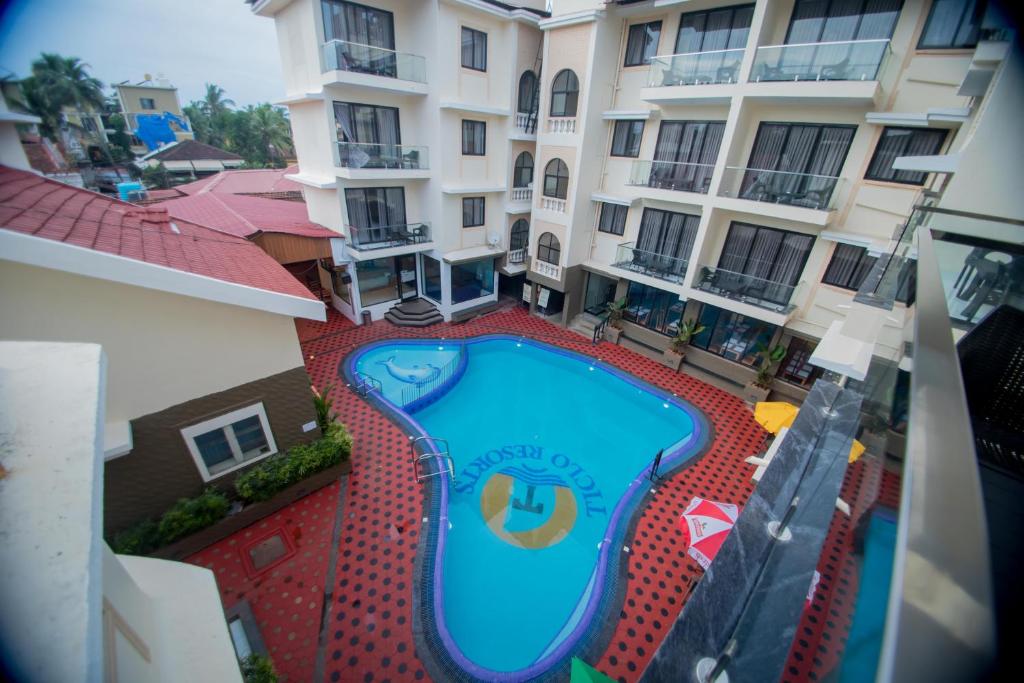 an overhead view of a swimming pool in front of a building at Ticlo Resorts in Calangute