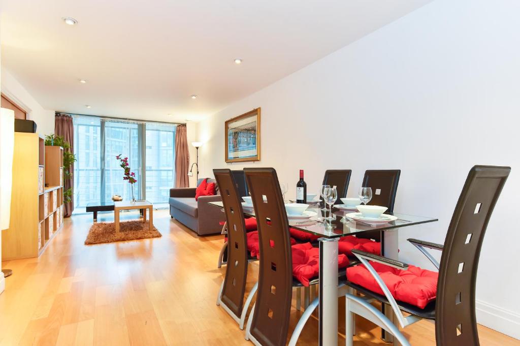 a dining room with a table and chairs at Paddington Gardens in London