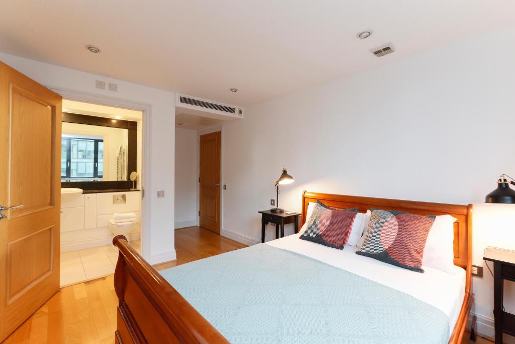 a bedroom with a bed and a bathroom at Paddington Gardens in London
