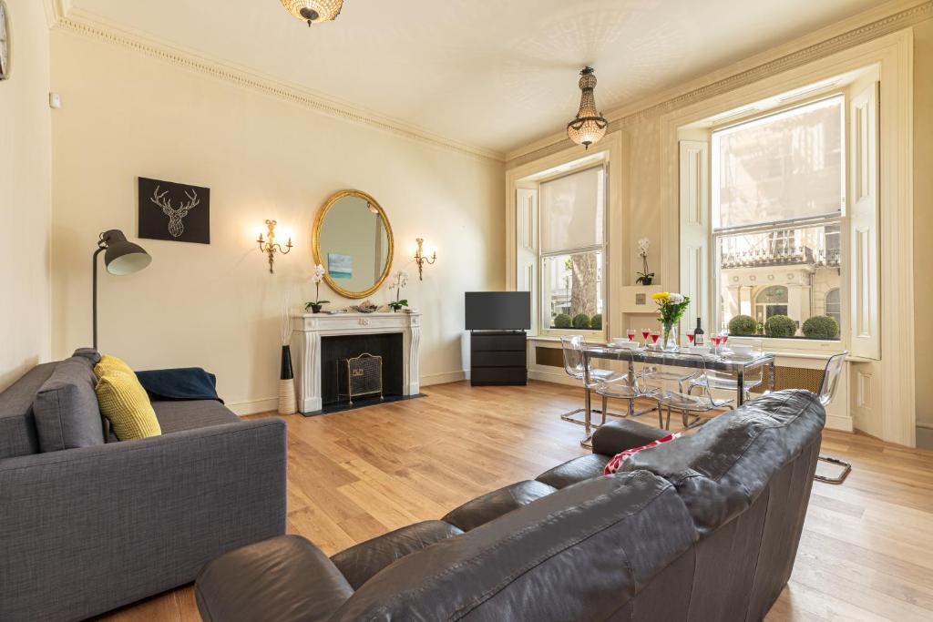 a living room with a couch and a table at Paddington Gardens in London
