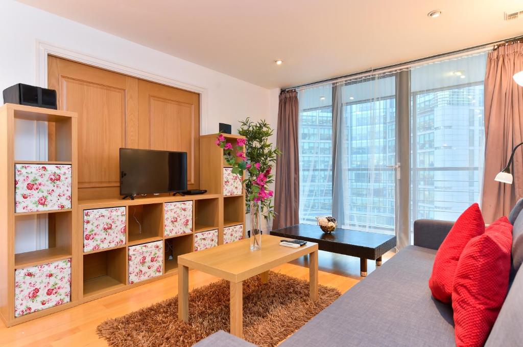 a living room with a couch and a table at Paddington Gardens in London