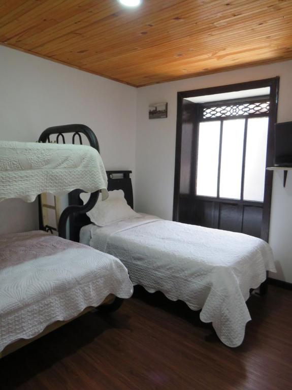 Postel nebo postele na pokoji v ubytování Hotel Aroma del Bosque Posada Cafe