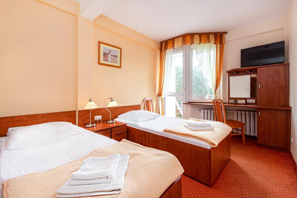 Postel nebo postele na pokoji v ubytování Hotel Ustka