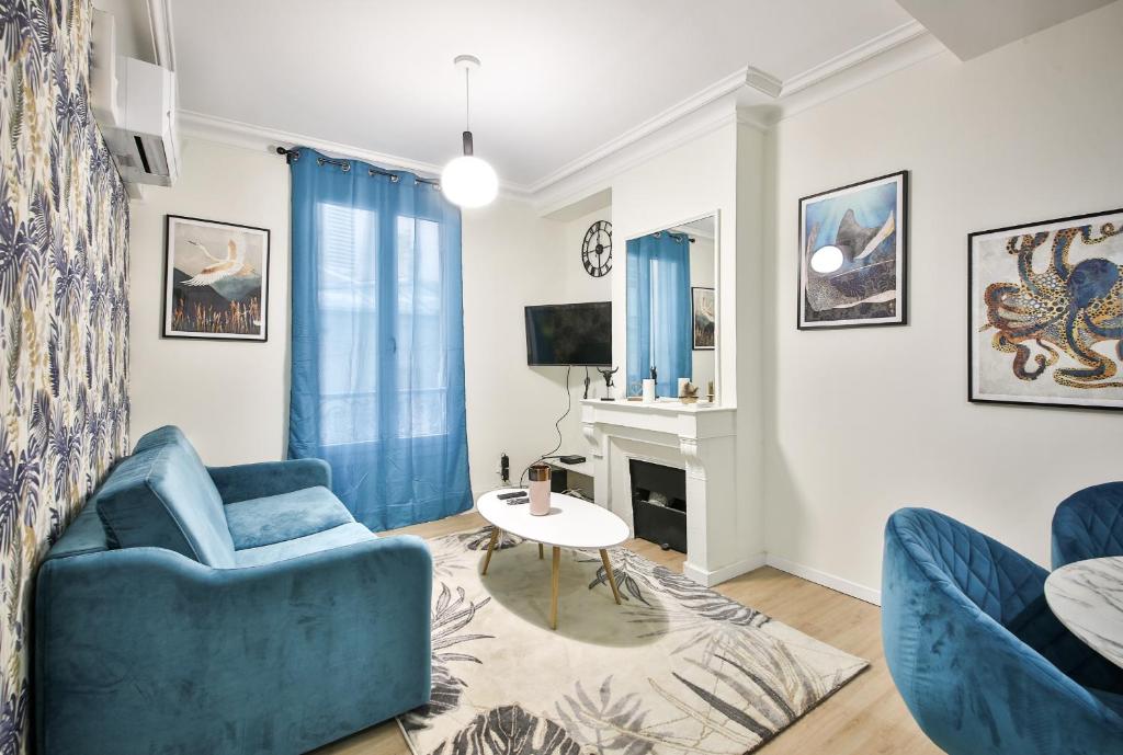 un salon avec un canapé bleu et une table dans l'établissement B0#Appart 4pers#Champs Elysées#Arc de Triomphe, à Paris