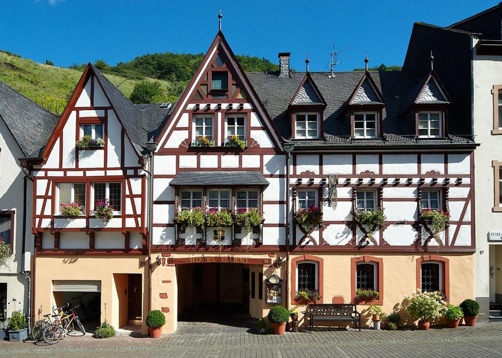 a large building with flower pots on the front of it at Alter Posthof Ferienwohnungen in Bernkastel-Kues