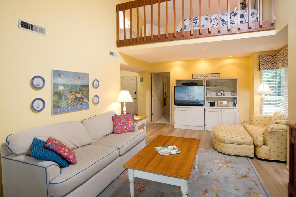 a living room with a couch and a table at Windward Village 109 in Hilton Head Island