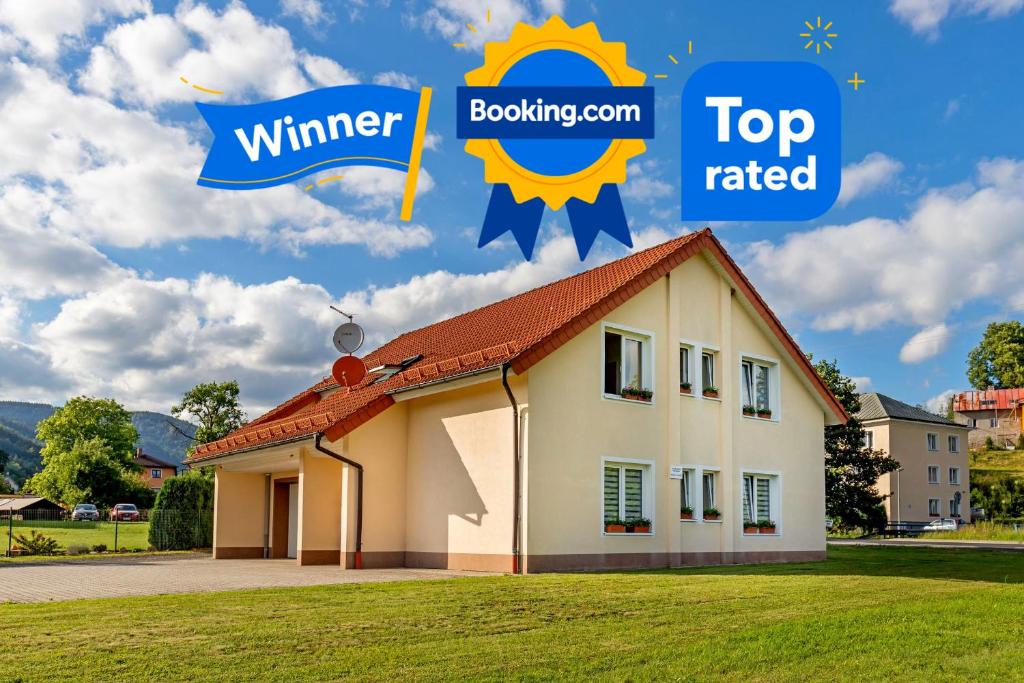 a house with the words top rated and the word winner at Pension Nataliya in Ostrov