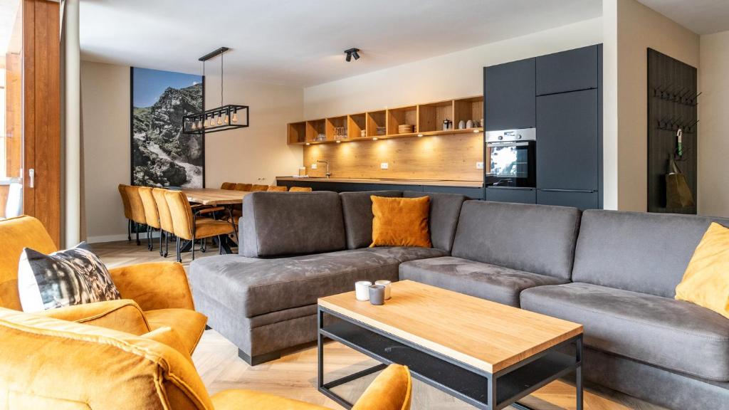 a living room with a couch and a table at UplandParcs Silvretta in Schruns