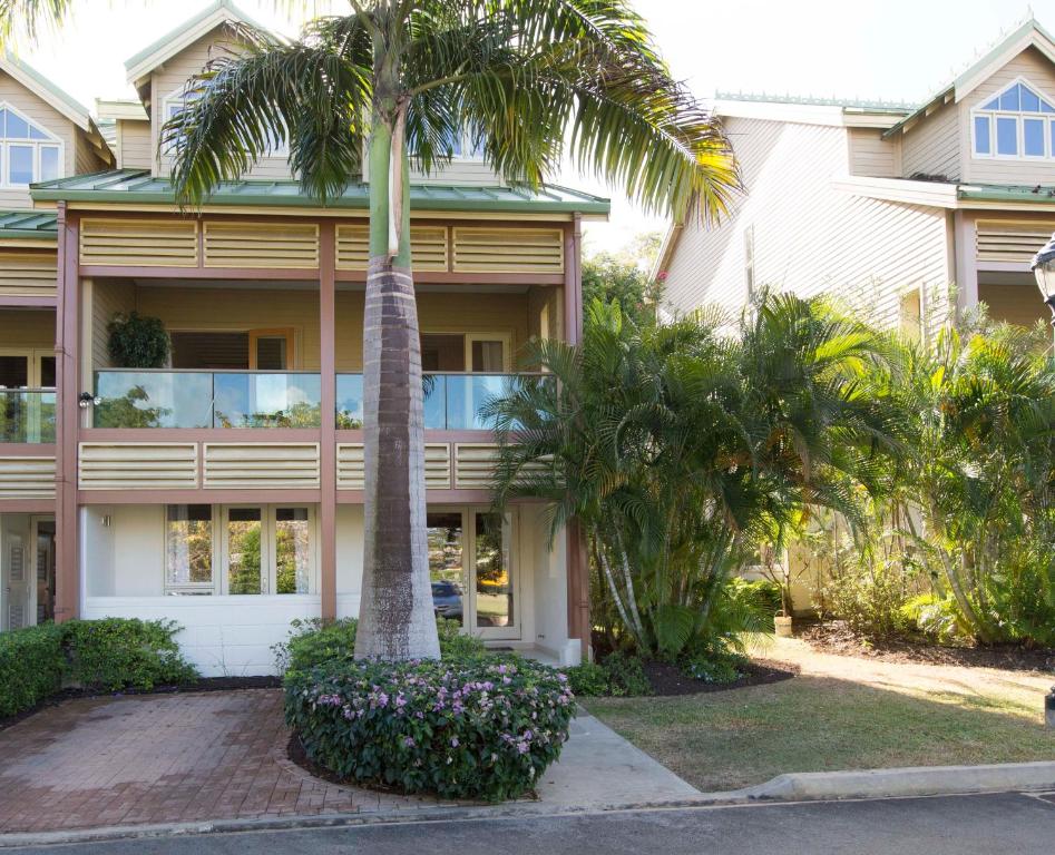 a palm tree in front of a building at Luxury 3-Bed Villa St James near Beach & Gym in Saint James