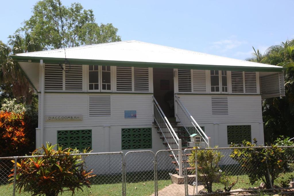 a white house with a fence in front of it at Daggoombah Holiday Home Magnetic Island in Arcadia