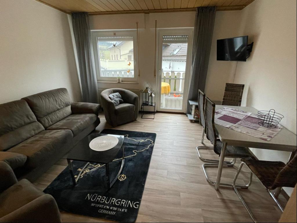 a living room with a couch and a table at Relaxen am Ring Fewo 2 in Wimbach