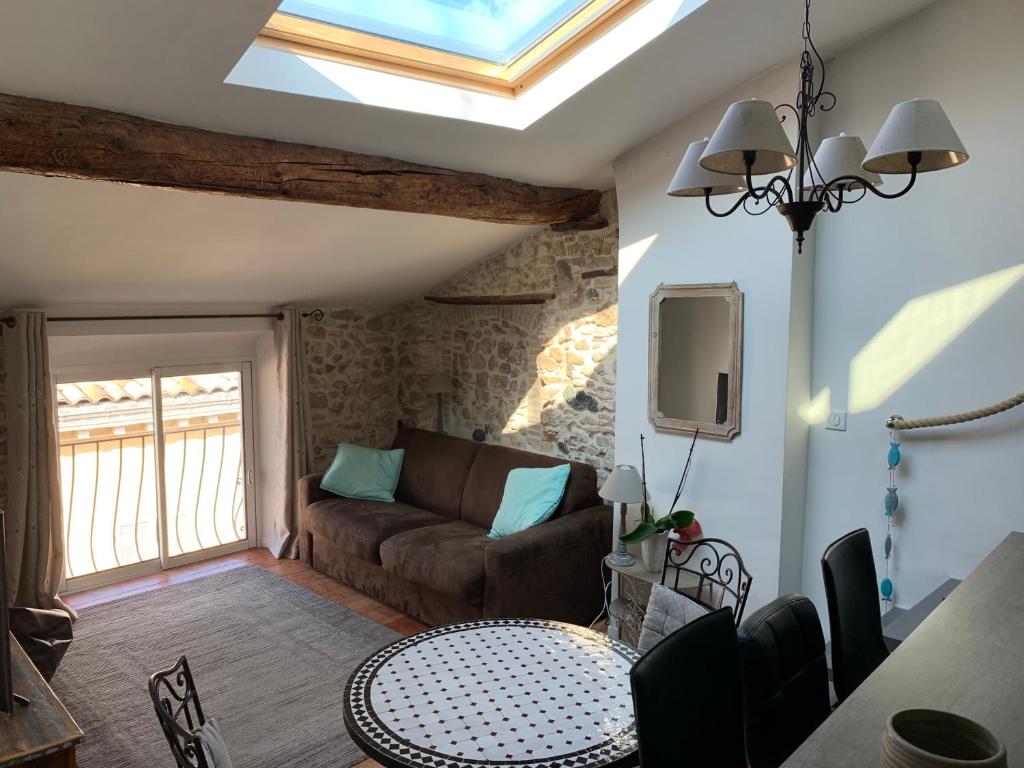 a living room with a couch and a table at Loft 3 pièces dans vieil Antibes in Antibes