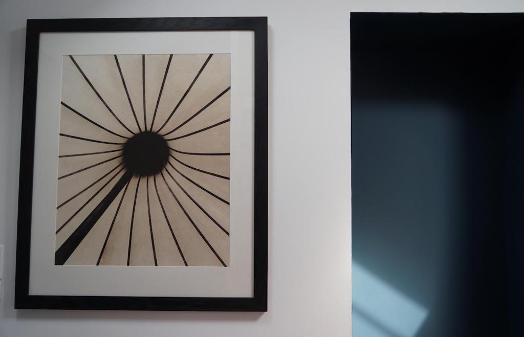 a framed picture of a wheel on a wall at Kermaria Studio Suite in Pont-Aven