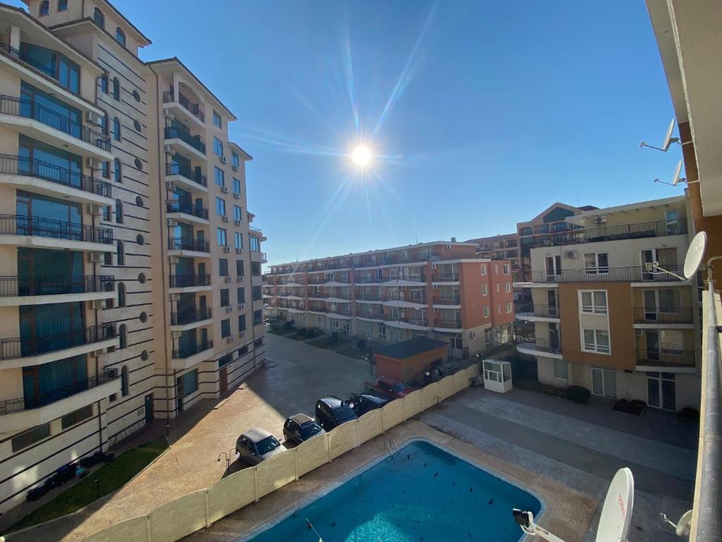 a view from the balcony of a building with a pool at BLUE MARINE C16 Apartment Sunny Beach in Sunny Beach