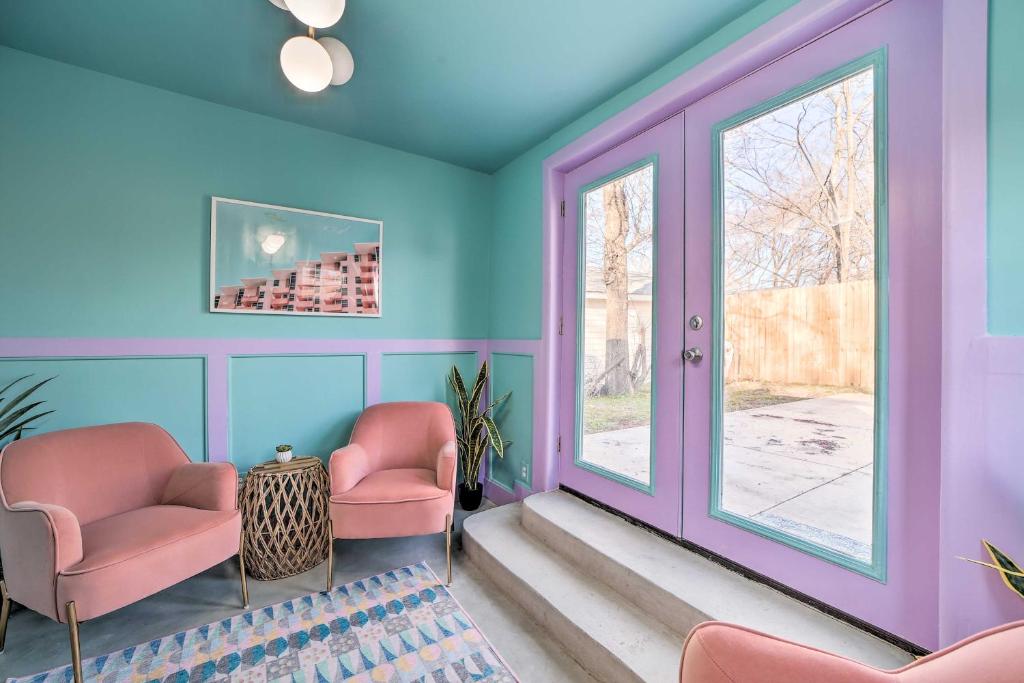 a waiting room with pink chairs and a window at Unique, Themed Tulsa Escape about 2 Mi to Downtown! in Tulsa