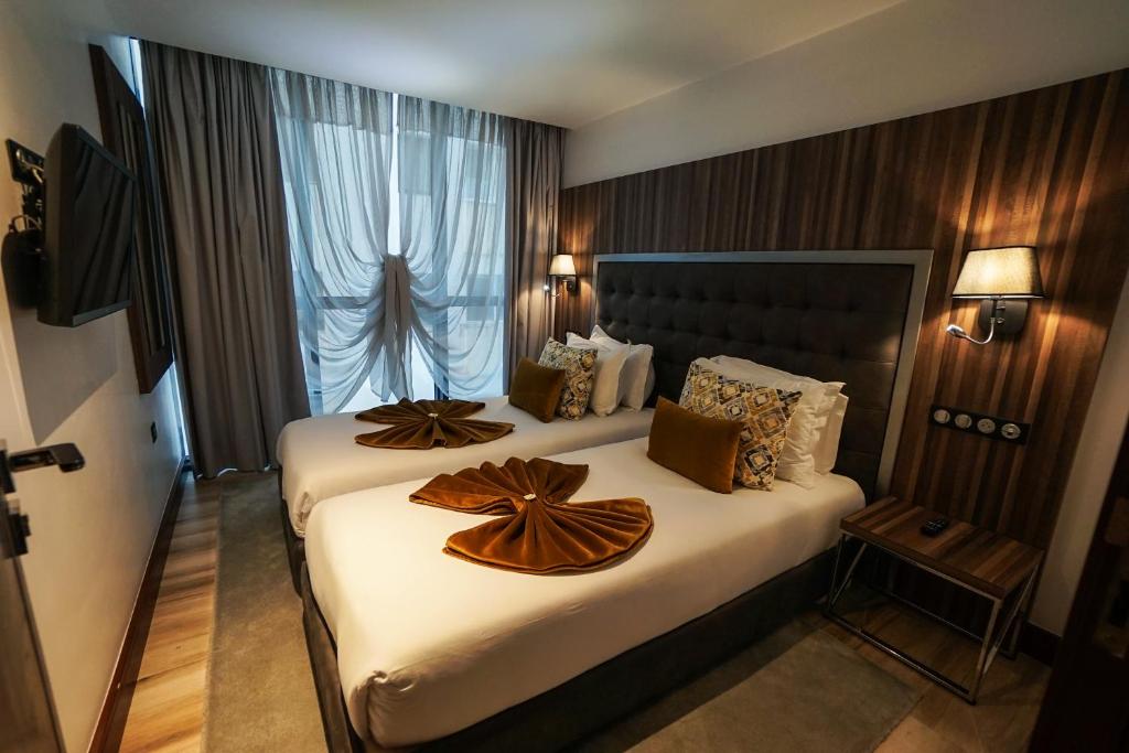 Postel nebo postele na pokoji v ubytování SBN Suite Hôtel