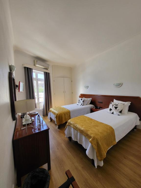 Postel nebo postele na pokoji v ubytování Hotel Beira Mar