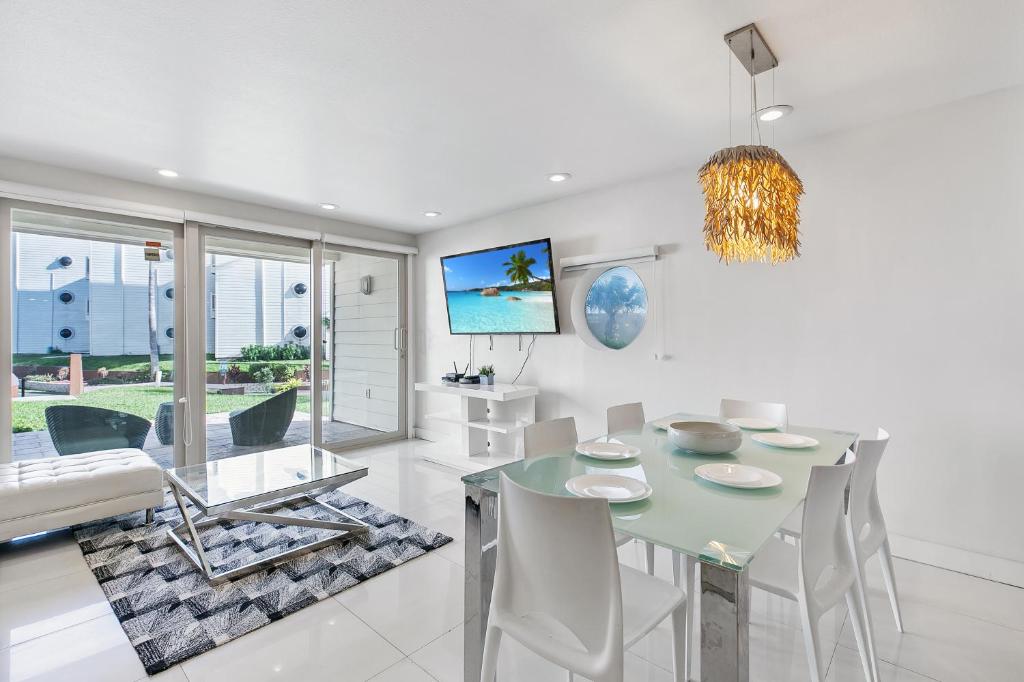 a dining room with a table and chairs at Ground Level Pet-Friendly Condo Seconds from Beach in South Padre Island