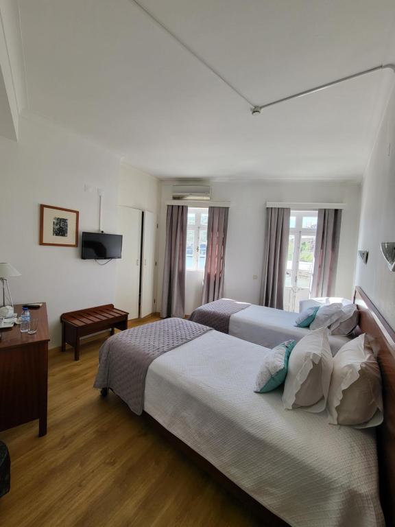 Postel nebo postele na pokoji v ubytování Hotel Beira Mar