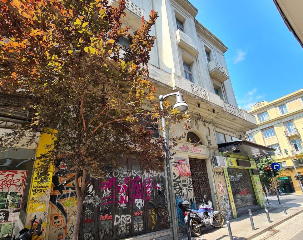 a building on a street with a motorcycle parked in front at Jetpak Alternative Eco Hostel in Thessaloniki