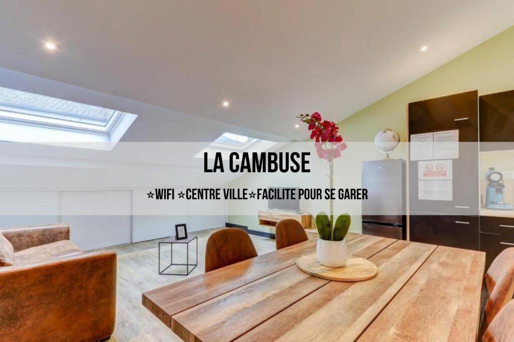 a dining room with a wooden table and chairs at LA CAMBUSE TOPDESTINATION-BOURG - Centre ville - Classé 3 étoiles in Bourg-en-Bresse