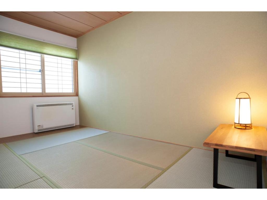 an empty room with a table and a window at Guest House Tou - Vacation STAY 26341v in Kushiro