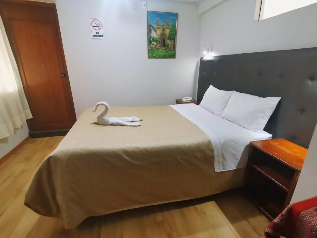 Postel nebo postele na pokoji v ubytování Hotel Urpi Cusco