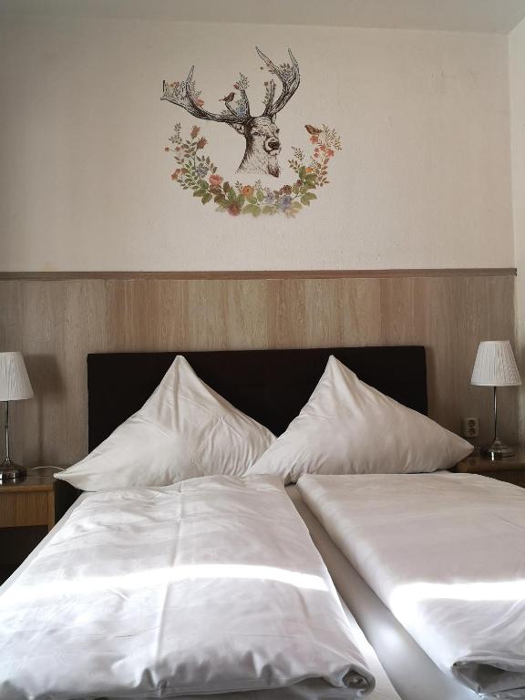a bedroom with a bed with a deer on the wall at Hotel Hohenstein -Radweg-Messe-Baldeneysee in Essen