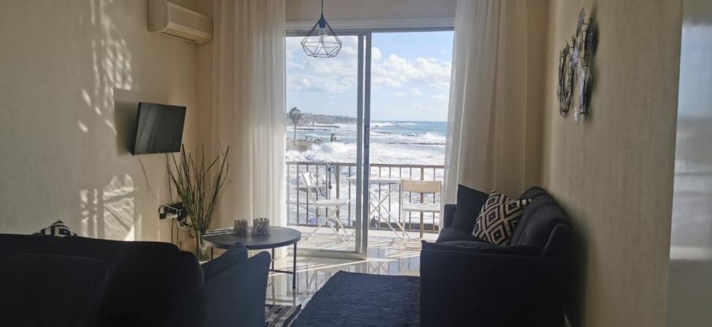 a living room with a view of the ocean at Castle apartment in Paphos City