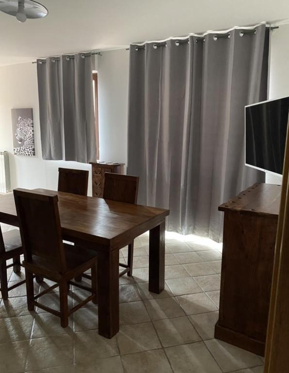 a dining room with a wooden table and chairs at Silio 12 in Foligno