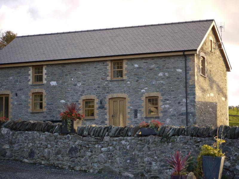 an old stone building with a stone wall at BREATHTAKING VIEWS with a HOT TUB - Bwlch Cliced in Talybont