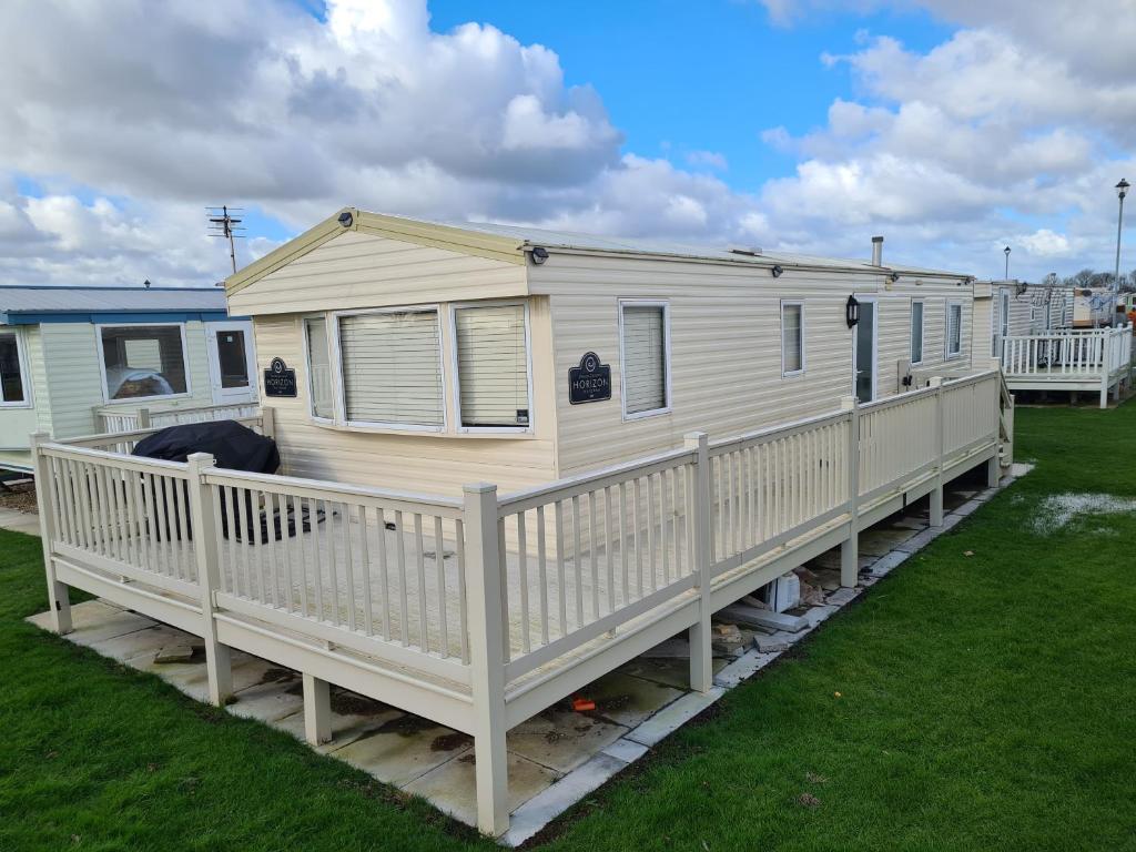 a mobile home with a porch and a deck at 8 Berth The Chase Ingoldmells (Horizon) in Ingoldmells