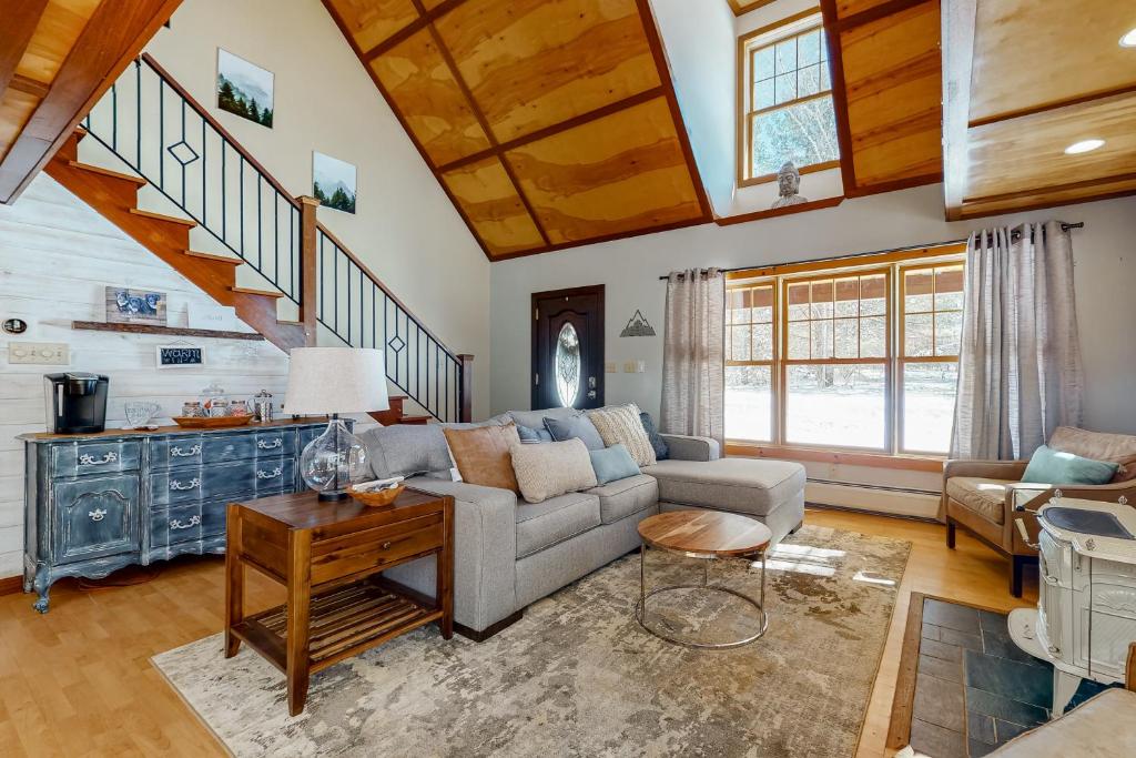 a living room with a couch and a table at Alpine Retreat in Madison