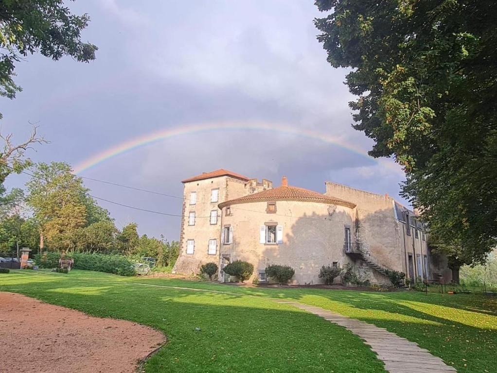 a rainbow in the sky above a castle at Tour du Château de Gondole in Le Cendre
